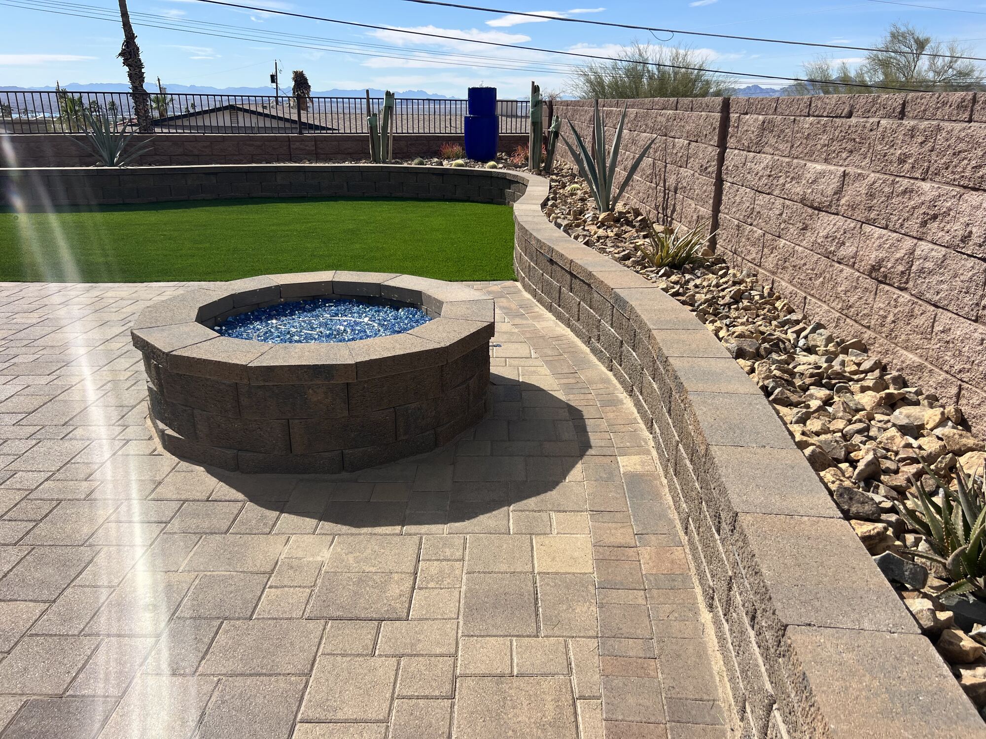 Fire Pit, Turf & Curved Seat Wall by Havasu Pavers in Lake Havasu City